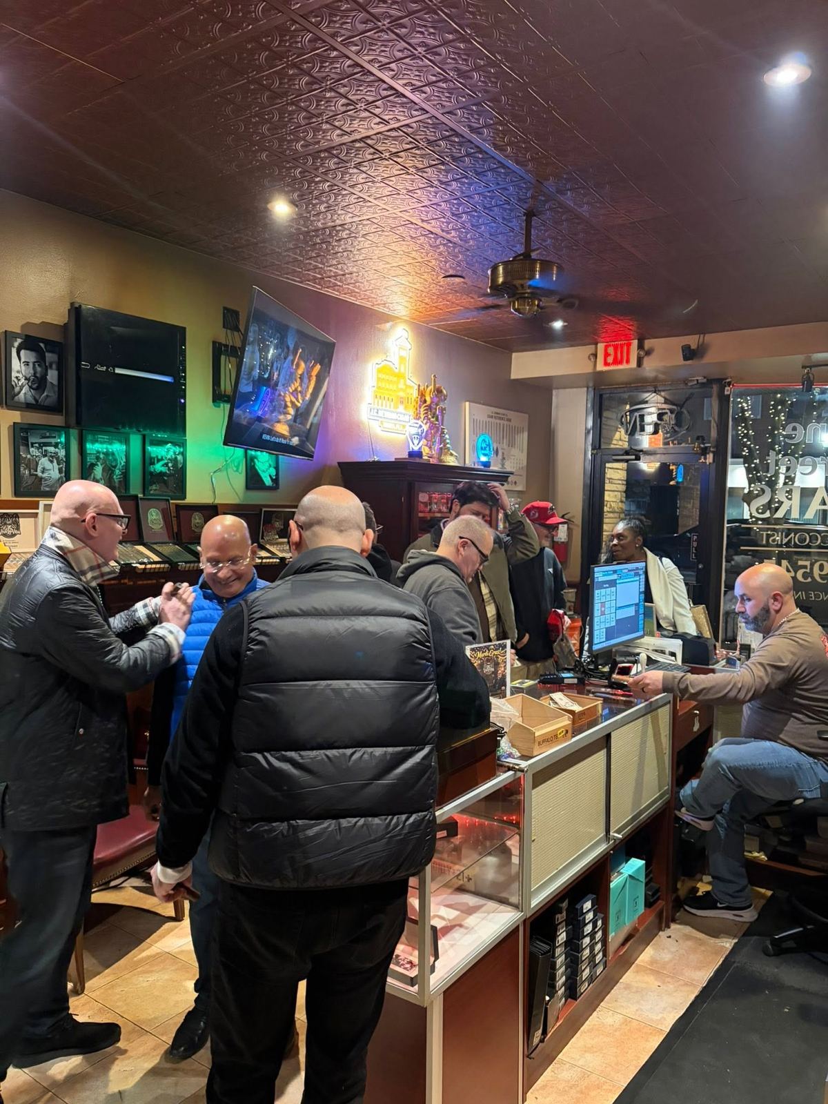 A busy night at the Mane Street Cigars counter with customers picking cigars